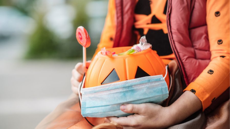 Jack O' Lantern treat basket with a disposable face mask (Getty Images)