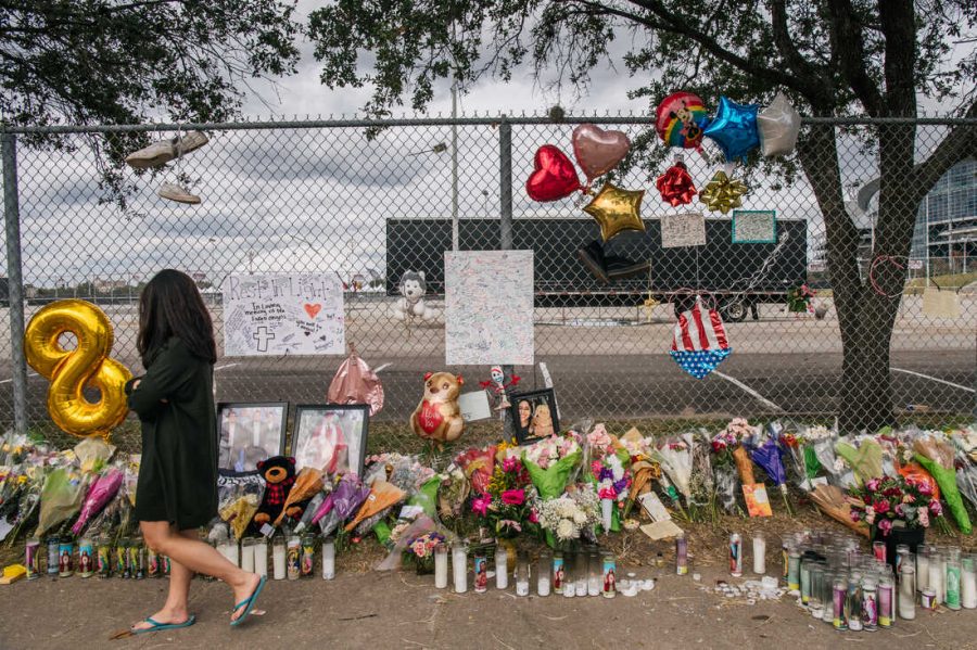 HOUSTON, TEXAS - NOVEMBER 09: A woman walks past a memorial to those who died at the Astroworld festival outside of NRG Park on November 09, 2021 in Houston, Texas. Eight people were killed and dozens injured last Friday in a crowd surge during a Travis Scott concert at the Astroworld music festival. Several lawsuits have been filed against Scott, and authorities continue investigations around the event. Scott, a Houston-native rapper and musician, launched the festival in 2018. (Photo by Brandon Bell/Getty Images)