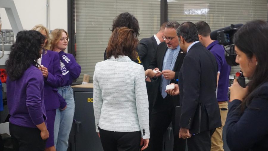 U.S. Secretary Miguel Cardona, Gina Raimondo, and U.S. Senator Raja Krishnamoorthi receive soap bars created and engraved by RMHS Manufacturing Students.